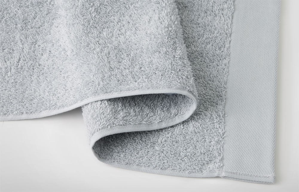 Terry cloth bath towel composition Stock Photo by ©exopixel 58769643