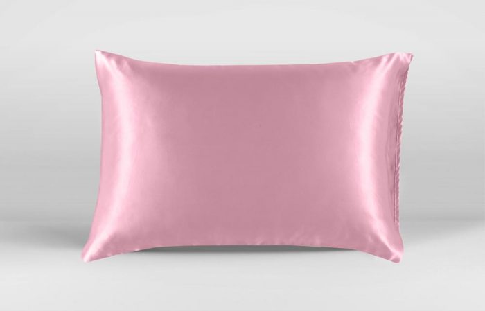 Medium wide shot of pillow with pink silk pillowcase